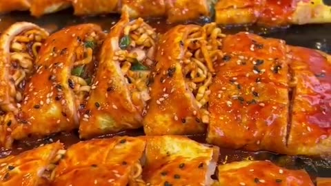 Eggs pancake stuffed with spicy noodles and cheese