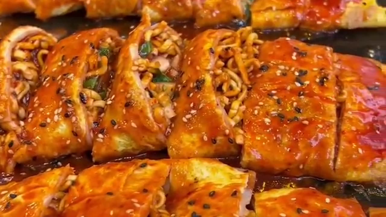 Eggs pancake stuffed with spicy noodles and cheese