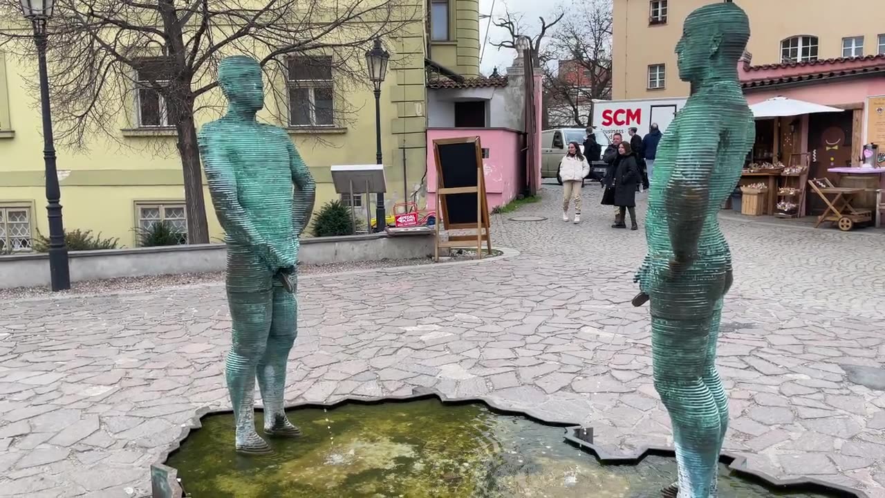 Piss Sculture by David Černý in front Kafka Museum Prague