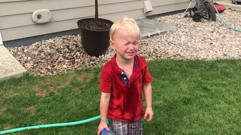 Three-Year-Old Keeps Spraying Himself With Water Hose
