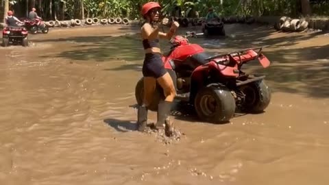 Girl Falls Into Muddy Water While Attempting to do Donut on Quad Bike