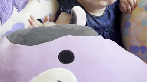 Cute Baby Kayla Surrounded by Squishmallows: Funny Plush Toy Moments