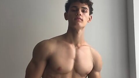 20 years old bodybuilder flexing muscles