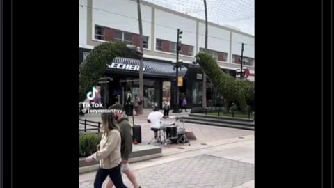 Dude is unknowingly street performing in front of the lead drummer of the song he’s performing
