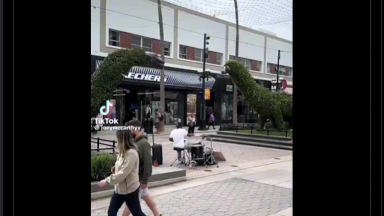 Dude is unknowingly street performing in front of the lead drummer of the song he’s performing
