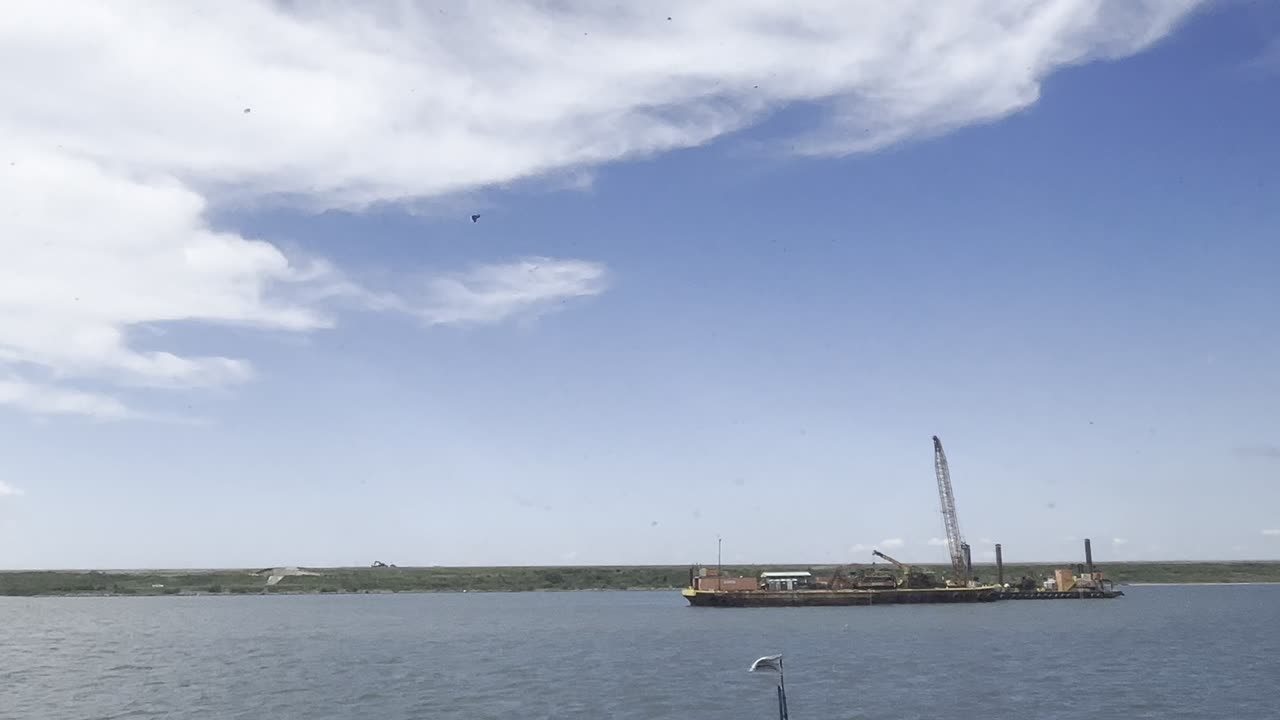 Tug boat getting made up to barge and getting underway