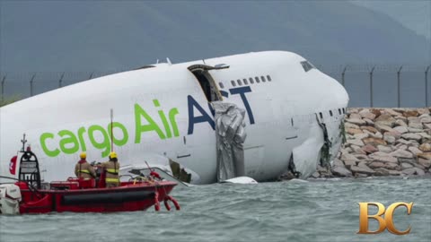 A cargo aircraft skids off a Hong Kong runway into the sea, killing 2 airport workers