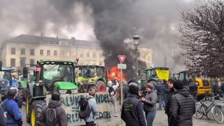 Farmers light fire outside of the European Parliament
