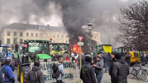 Farmers light fire outside of the European Parliament
