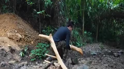 A man builds a cozy house in the forest with his own hands
