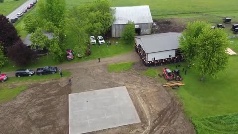 Drone Footage of 150 Amish Men in New York Moving a Barn