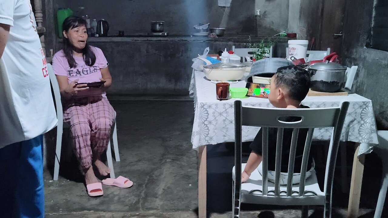 Isaiah Watching on Phone while Lola Janet Eats