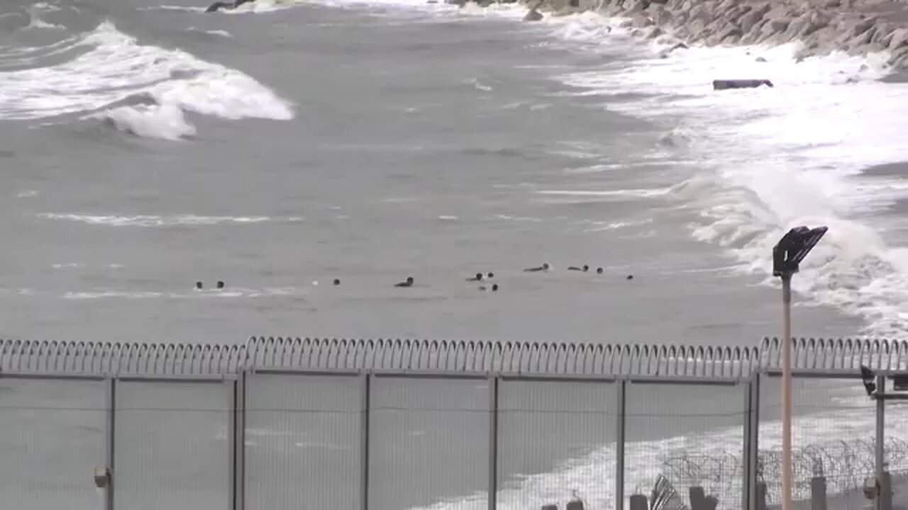 Children among migrants swimming from Morocco to Spanish Enclave