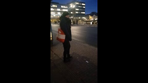Beautiful young woman freezes while waiting for the bus.