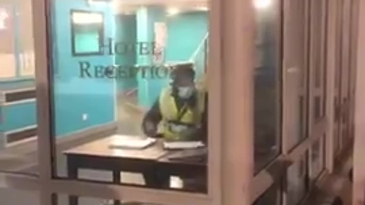 Homeless British couple sleeping on a mattress in migrant hotel carpark