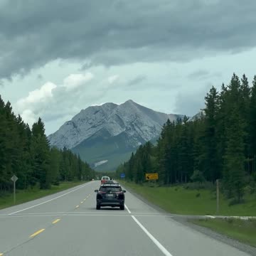Scenic Drive Towards Majestic Mountain Range