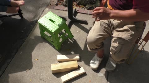 Luodong Massages His Feet On The Sidewalk