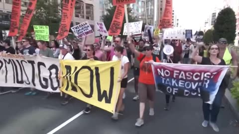 Thousands of protesters chant Fuck Trump! as they march through the streets of DC