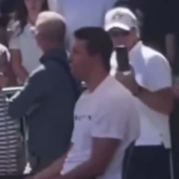 Who is the person behind Charlie Kirk and why is he making what appears to be a “signal”