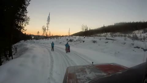 Girls knee boarding behind the truck in 2' of snow