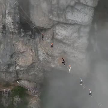 Whoa! Tourists climbing China's Huangshan Mountains with hanging ladders…