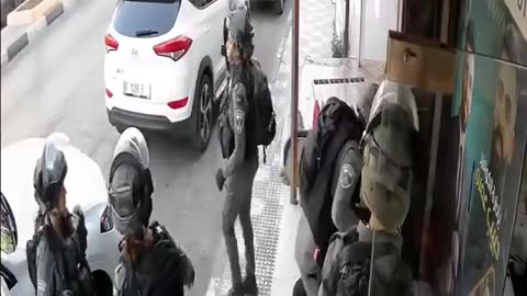 Occupation soldiers assaulted a Palestinian young man sitting in front of his shop