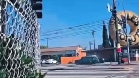Is this LA protester seriously shooting at the police? What the hell is going on?
