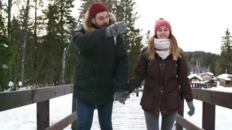Couple walking and enjoying in snow