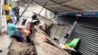 Heavy rain in central Colombia opens crater in street