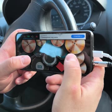 Talent plays drums with the app Real Drum