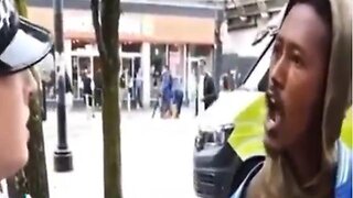 Migrant says fuck you bitch to police woman. Then policeman offers to take the handcuffs off