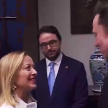 Italian Prime Minister Giorgia Meloni greets Elon Musk.