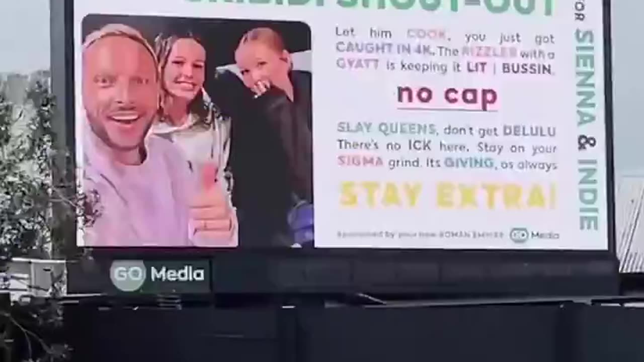 Father creates a billboard for his daughters.