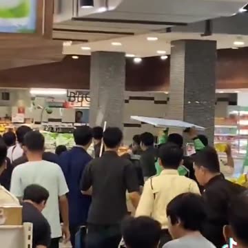 Illegal African inside a supermarket and douses himself with cooking oil in Indonesia