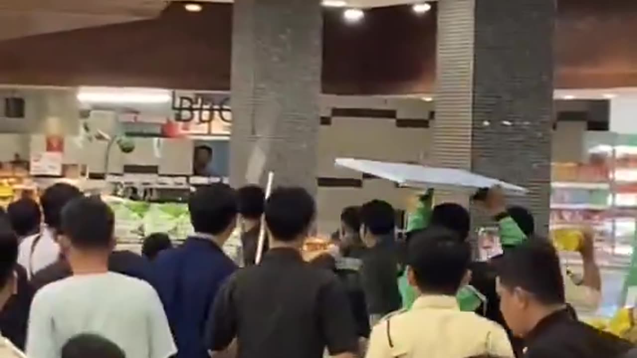 Illegal African inside a supermarket and douses himself with cooking oil in Indonesia