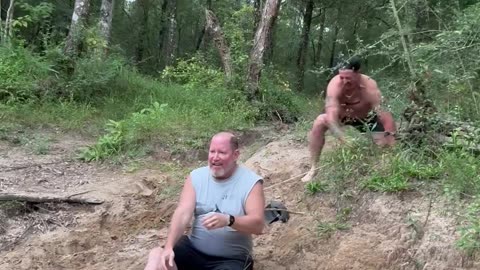 Dad and Stepson Laughing and Slipping on a Sandy Hill
