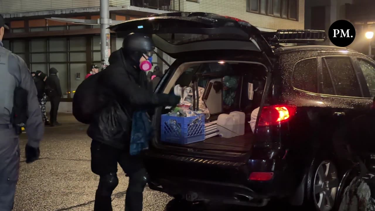 Anti-ICE demonstrators rush to remove and salvage supplies after Portland Police