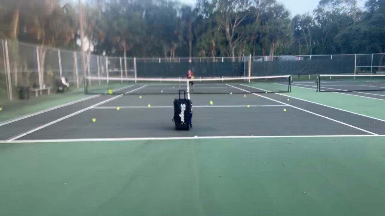 Practicing low tennis volleys