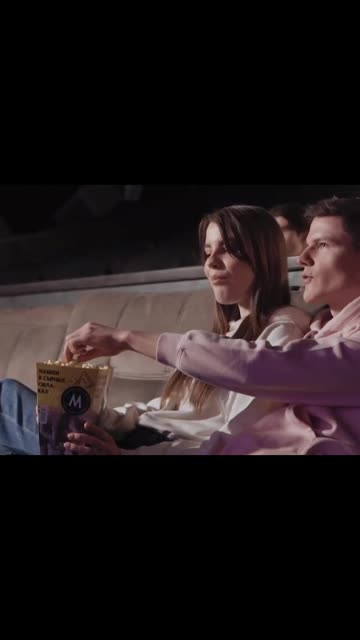 Beautiful couple eating popcorn and enjoying