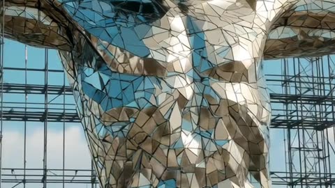 A monumental Jesus sculpture built entirely from mirrored steel