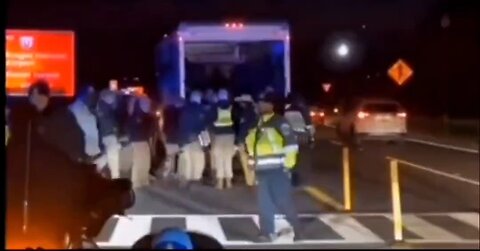 Police standing guard while Patriot Front loads up in Uhaul
