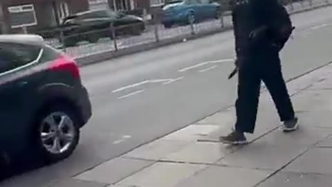 Migrant calmly walking down the street in Liverpool, L30, this morning openly
