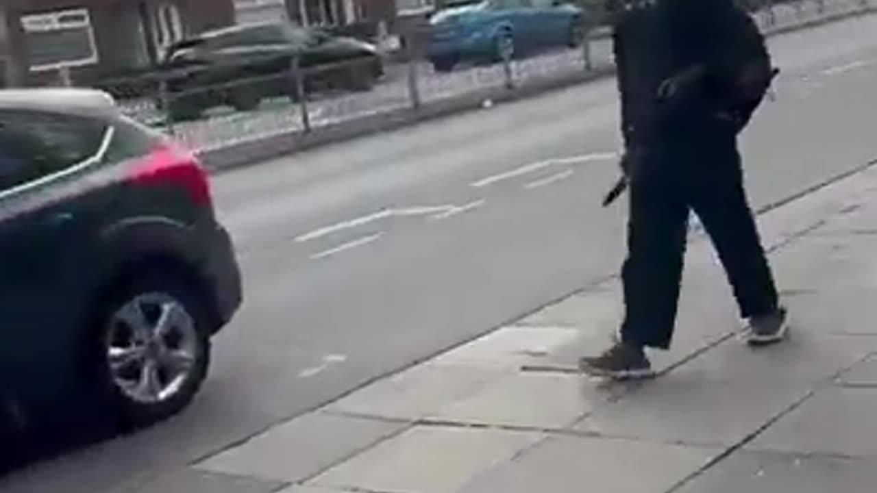 Migrant calmly walking down the street in Liverpool, L30, this morning openly