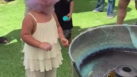 This girl is teaching us the right way how to eat cotton candy.