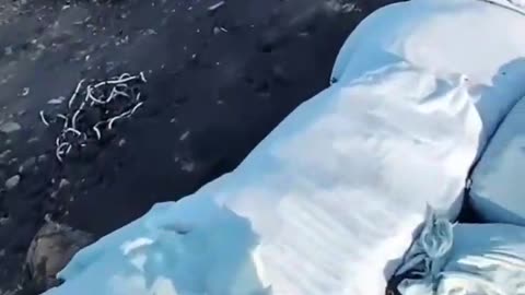Russian Soldiers Walking Amongst Craters Full of Motorbikes