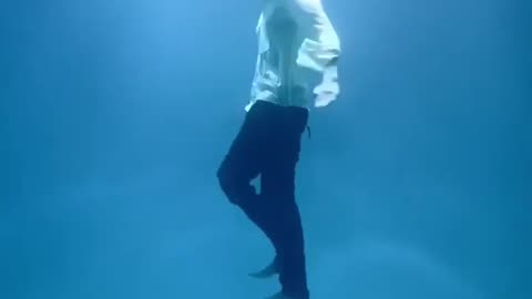 Indian man performs an underwater pendulum