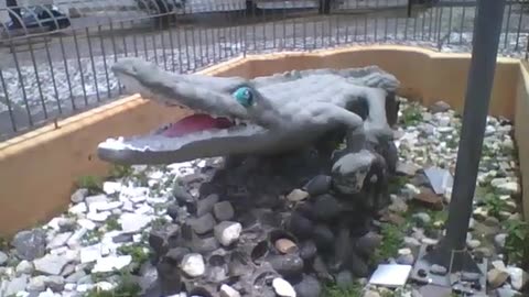 Amazing stone sculpture of an alligator in the square, look the teeth! [Nature & Animals]