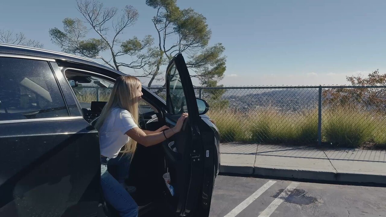 Woman Stepping Out of Car to...