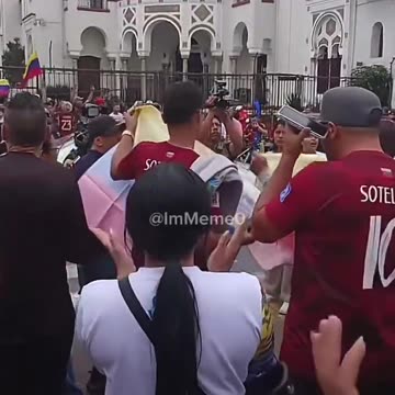 Venezuelans are flooding the streets, draped in and waving their national flags, celebrating