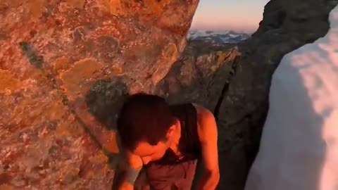 Trail running legend Kilian Jornet hopping across a razor-thin ridge at the sunrise.